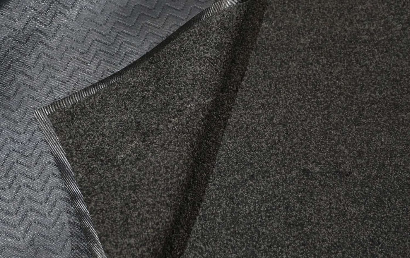 A remanufactured walk-off mat with a new border installed at a doorway